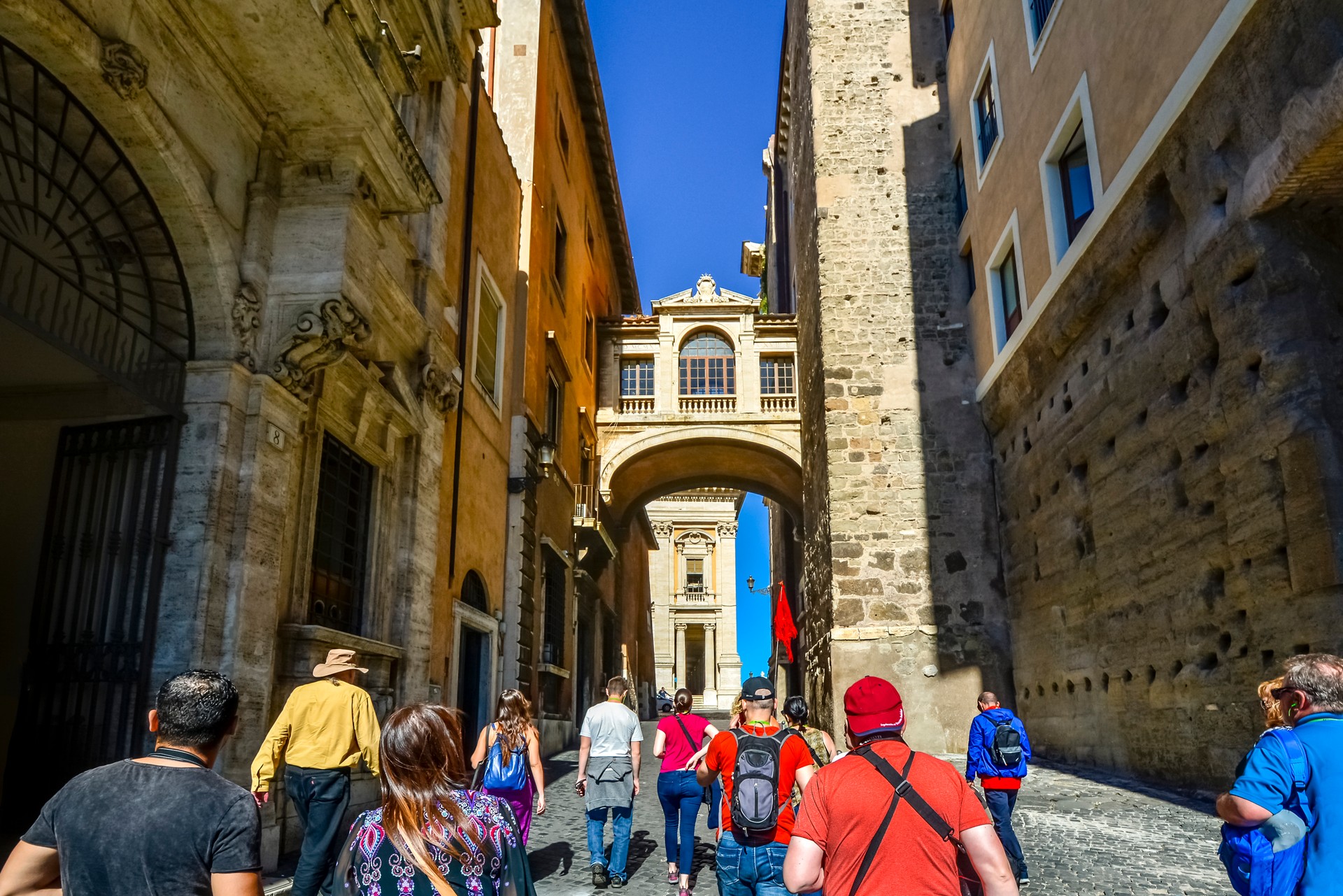 A tour guide leads a group of tourists through Capitoline Hill and the Portico dii Consentes near the Roman Forum in Rome Italy